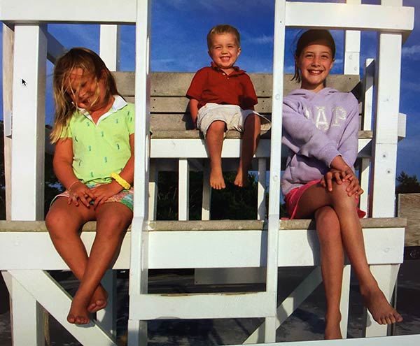 Children sitting atop the lifeguard's chair at Children's Beach, a short walk from the Queen Anne Inn